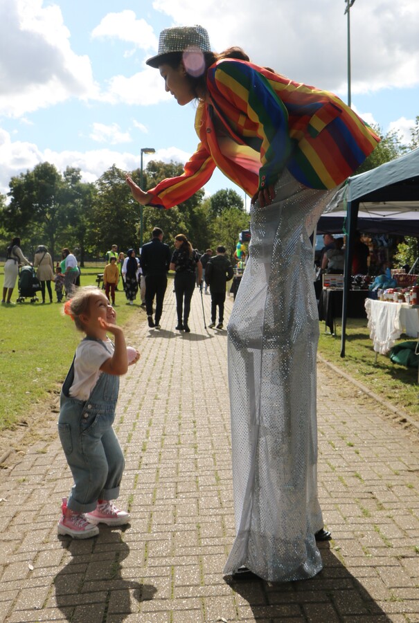 Stilt walker greeting young visitor